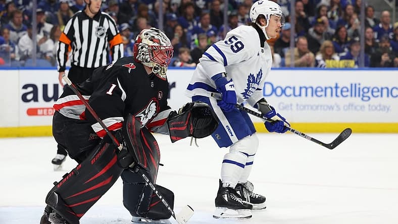 Mar 30, 2024; Buffalo, New York, USA; Buffalo Sabres goaltender Ukko-Pekka Luukkonen (1) and Toronto Maple Leafs left wing Tyler Bertuzzi (59) look for the puck during the first period at KeyBank Center. Mandatory Credit: Timothy T. Ludwig-USA TODAY Sports
