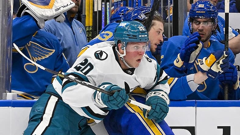 Mar 30, 2024; St. Louis, Missouri, USA;  San Jose Sharks left wing Fabian Zetterlund (20) checks St. Louis Blues left wing Jake Neighbours (63) during the first period at Enterprise Center. Mandatory Credit: Jeff Curry-USA TODAY Sports