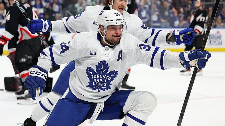 Mar 30, 2024; Buffalo, New York, USA;  Toronto Maple Leafs center Auston Matthews (34) reacts after scoring his 60th goal of the year during the third period against the Buffalo Sabres at KeyBank Center. Mandatory Credit: Timothy T. Ludwig-USA TODAY Sports