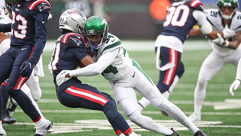 Sep 24, 2023; East Rutherford, New Jersey, USA; New England Patriots wide receiver Demario Douglas (81) is tackled by New York Jets cornerback Justin Hardee (34) during the first half at MetLife Stadium. Mandatory Credit: Vincent Carchietta-USA TODAY Sports