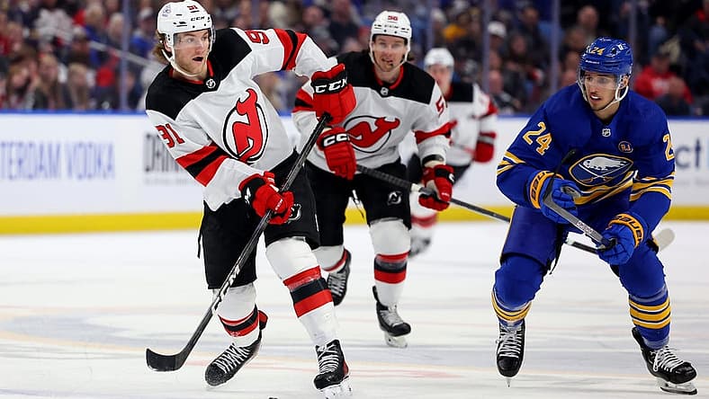 Mar 29, 2024; Buffalo, New York, USA;  Buffalo Sabres center Dylan Cozens (24) watches as New Jersey Devils center Dawson Mercer (91) makes a pass during the third period at KeyBank Center. Mandatory Credit: Timothy T. Ludwig-USA TODAY Sports