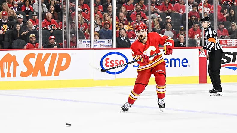 CALGARY, AB - OCTOBER 18: Calgary Flames Defenceman Rasmus Andersson (4) passes the puck during the second period of an NHL game between the Calgary Flames and the Vegas Golden Knights on October 18, 2022, at the Scotiabank Saddledome in Calgary, AB. (Photo by Brett Holmes/Icon Sportswire)