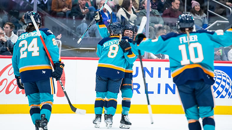 New York Sirens forwards Sarah Fillier, Paetyn Levis, and Anne Cherkowski celebrate with Maja Nylen Persson during a 2-1 win over the Montreal Victoire.