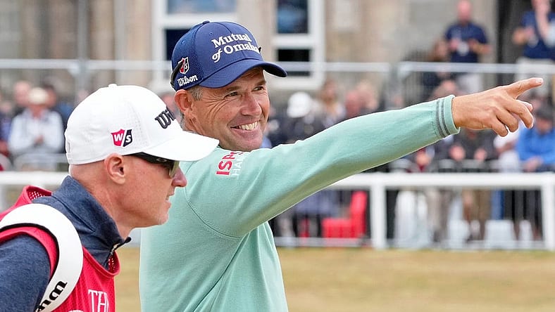 Jul 14, 2022; St. Andrews, SCT; Padraig Harrington smiles as he gestures while walking on the first fairway during the first round of the 150th Open Championship golf tournament at St. Andrews Old Course. Mandatory Credit: Michael Madrid-USA TODAY Sports