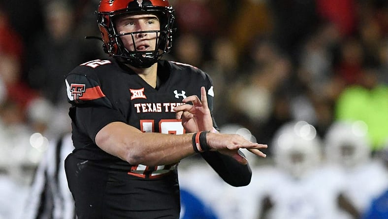 Texas Tech's quarterback Tyler Shough (12) throws a pass to Texas Tech's tight end Mason Tharp (80) for a touchdown against Kansas in a Big 12 football game, Saturday, Nov. 12, 2022, at Jones AT&T Stadium.