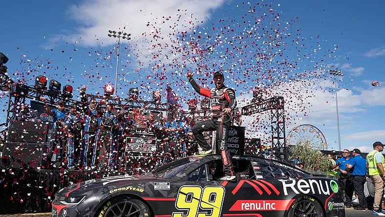 Jun 12, 2022; Sonoma, California, USA; NASCAR Cup Series driver Daniel Suarez (99) celebrates his win of the NASCAR Toyota - Save Mart 350 race event at Sonoma Raceway. Mandatory Credit: Stan Szeto-USA TODAY Sports
