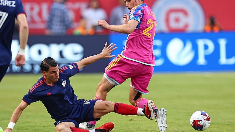 Jul 15, 2023; Chicago, Illinois, USA; Toronto FC defender Shane O'Neill (27) fouls Chicago Fire forward Georgios Koutsias (19) during the first half at Soldier Field. Mandatory Credit: Mike Dinovo-USA TODAY Sports