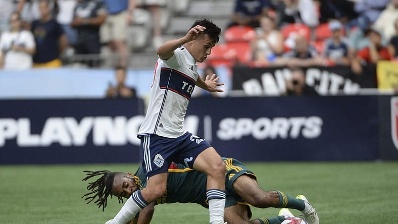Jul 15, 2023; Vancouver, British Columbia, CAN;  LA Galaxy forward Raheem Edwards (44) battles for the ball against Vancouver Whitecaps FC midfielder Andres Cubas (20) during the first half at BC Place. Mandatory Credit: Anne-Marie Sorvin-USA TODAY Sports