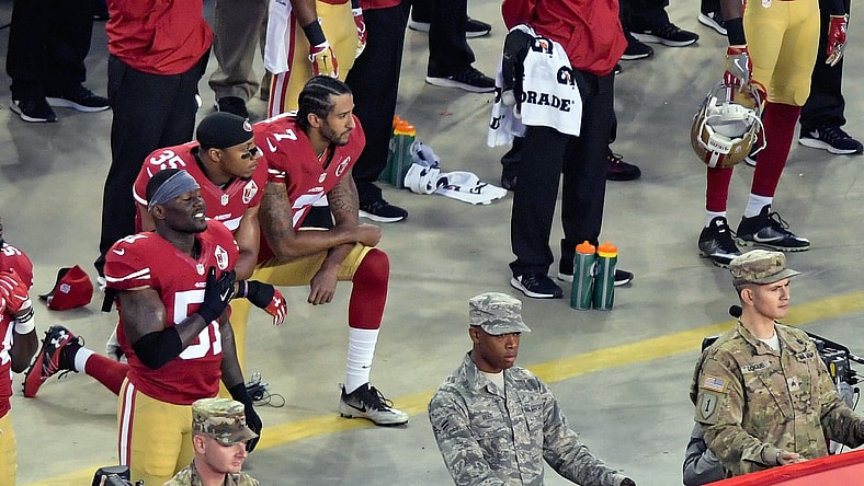Eric Reid and Colin Kaepernick kneel during the anthem