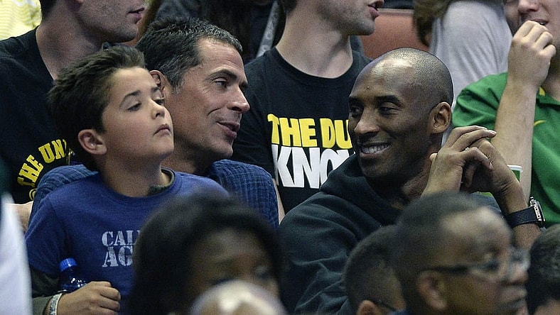 Caption: March 26, 2016; Anaheim, CA, USA; Los Angeles Lakers player Kobe Bryant with agent Rob Pelinka in attendance as the Oregon Ducks play against Oklahoma Sooners during the second half of the West regional final of the NCAA Tournament at Honda Center. Mandatory Credit: Richard Mackson-USA TODAY Sports
