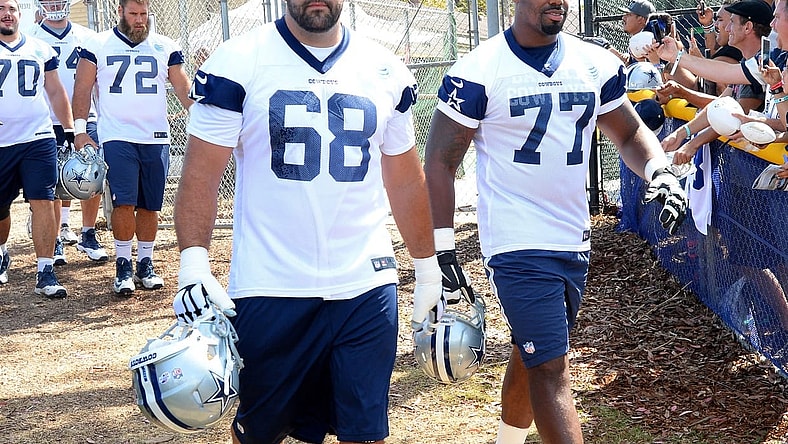 Caption: Jul 30, 2015; Oxnard, CA, USA; Dallas Cowboys tackle Doug Free (68) and tackle Tyron Smith (77) walk on to the field for the first day of training camp at River Ridge Fields. Mandatory Credit: Jayne Kamin-Oncea-USA TODAY Sports