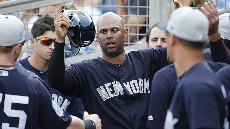 Yankees right fielder Aaron Hicks is congratulated in the dugout