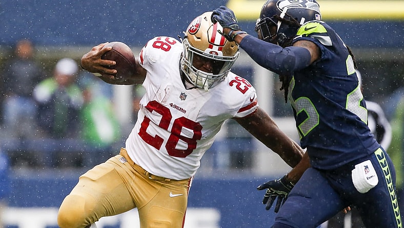 NFL San Francisco 49ers running back Carlos Hyde gets around Seattle Seahawks cornerback Richard Sherman