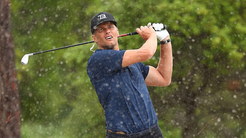 Tom Brady takes a shot during The Match