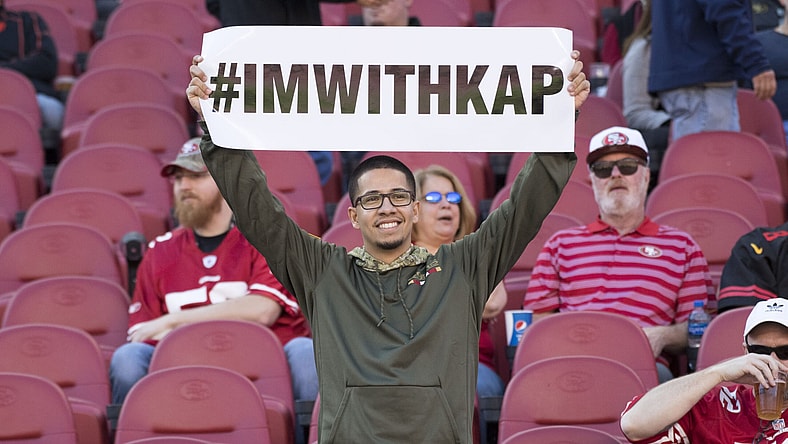 Fans show support for Colin Kaepernick's national anthem protests.