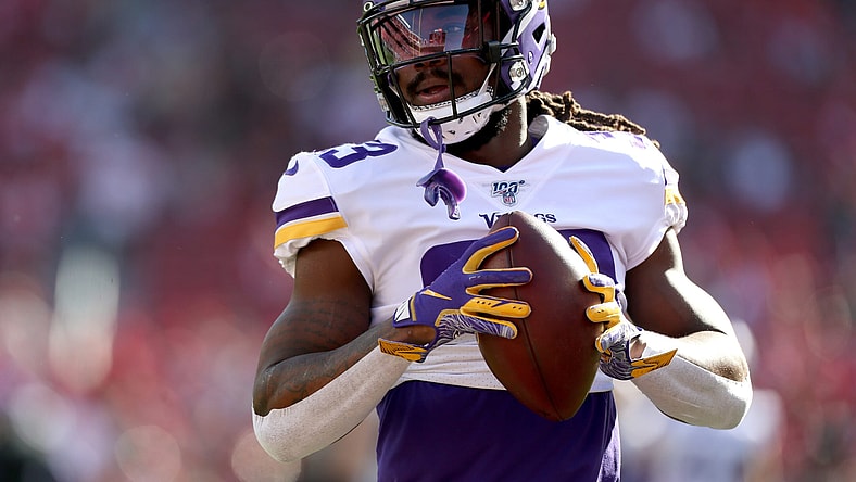 Dalvin Cook holds football