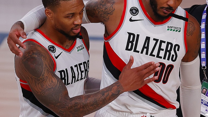 Carmelo Anthony and Damian Lillard during NBA game against 76ers.