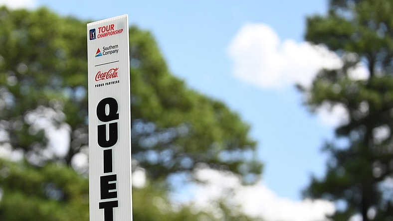 Aug 22, 2019; Atlanta, GA, USA; A marshall holds up a quiet sign during the first round of the Tour Championship golf tournament at East Lake Golf Club. Mandatory Credit: Adam Hagy-USA TODAY Sports