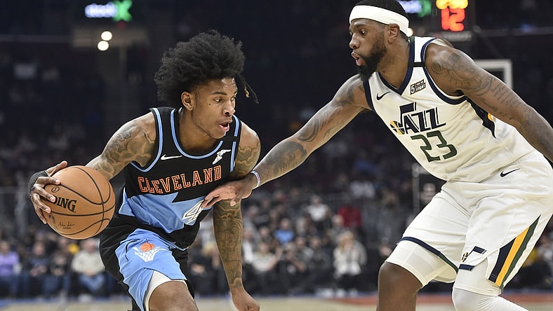 Mar 2, 2020; Cleveland, Ohio, USA; Cleveland Cavaliers guard Kevin Porter Jr. (4) drives against Utah Jazz forward Royce O'Neale (23) in the second quarter at Rocket Mortgage FieldHouse. Mandatory Credit: David Richard-USA TODAY Sports
