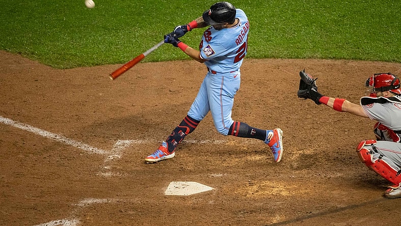 Sep 26, 2020; Minneapolis, Minnesota, USA; Minnesota Twins left fielder Eddie Rosario (20) hits a sacrifice fly against the Cincinnati Reds during the seventh inning at Target Field. Mandatory Credit: Jordan Johnson-USA TODAY Sports