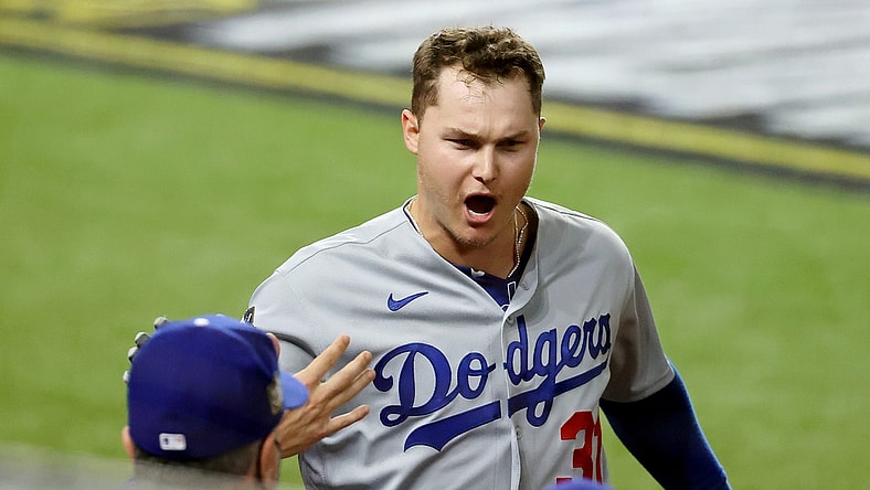 Oct 25, 2020; Arlington, Texas, USA; Los Angeles Dodgers left fielder Joc Pederson (31) is congratulated as he enters the dugout after hitting a home run against the Tampa Bay Rays during the first inning during game five of the 2020 World Series at Globe Life Field. Mandatory Credit: Kevin Jairaj-USA TODAY Sports