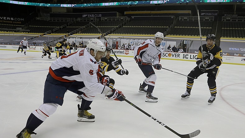 Jan 17, 2021; Pittsburgh, Pennsylvania, USA;  Washington Capitals left wing Alex Ovechkin (8) carries the puck against the Pittsburgh Penguins during the second period at the PPG Paints Arena. Mandatory Credit: Charles LeClaire-USA TODAY Sports