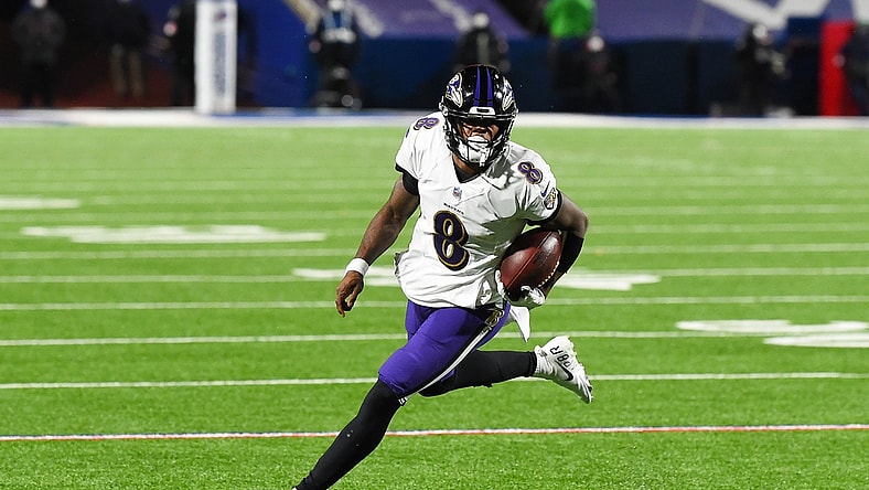 Jan 16, 2021; Orchard Park, New York, USA; Baltimore Ravens quarterback Lamar Jackson (8) runs with the ball against the Buffalo Bills during the third quarter of an AFC Divisional Round game at Bills Stadium. Mandatory Credit: Rich Barnes-USA TODAY Sports