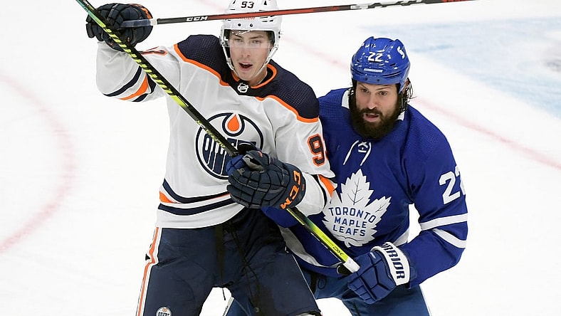 Jan 20, 2021; Toronto, Ontario, CAN;  Toronto Maple Leafs defenseman Zach Bogosian (22) covers Edmonton Oilers forward Ryan Nugent-Hopkins (93) in the third period at Scotiabank Arena. Mandatory Credit: Dan Hamilton-USA TODAY Sports