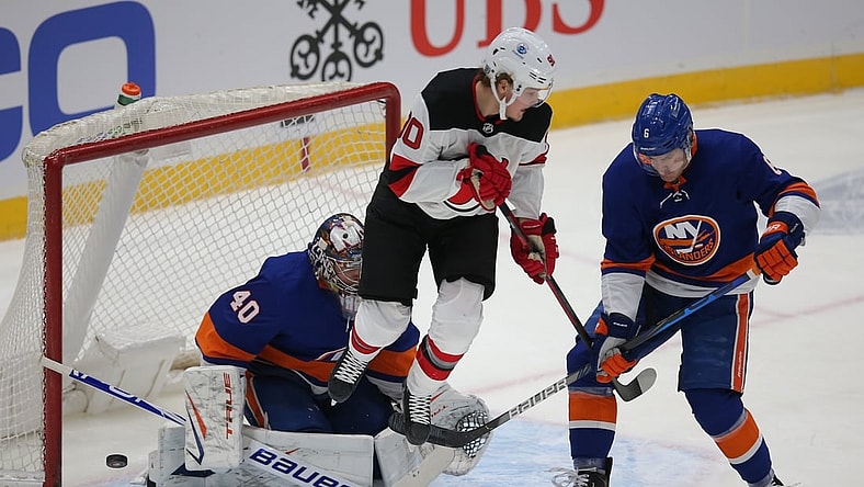 Jan 21, 2021; Uniondale, New York, USA; New York Islanders goalie Semyon Varlamov (40) makes a save against New Jersey Devils center Jesper Boqvist (90) in front of Islanders defenseman Ryan Pulock (6) during the first period at Nassau Veterans Memorial Coliseum. Mandatory Credit: Brad Penner-USA TODAY Sports
