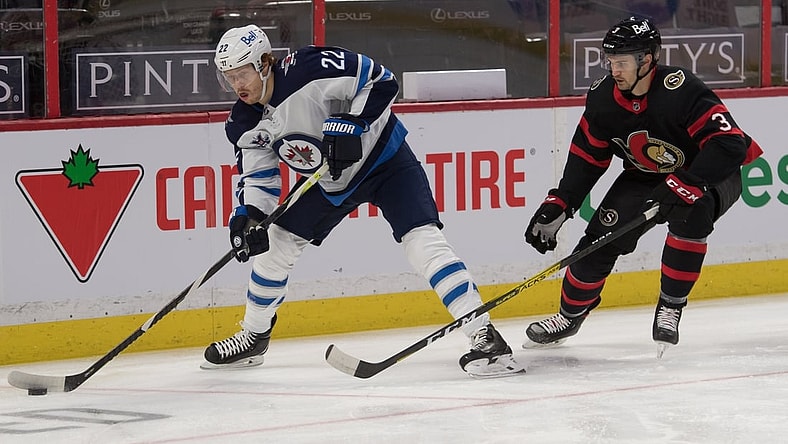 Jan 21, 2021; Ottawa, Ontario, CAN; Winnipeg Jets center Mason Appleton (22) skates with the puck in front of  Ottawa Senators defenseman Josh Brown (3) in the first period at the Canadian Tire Centre. Mandatory Credit: Marc DesRosiers-USA TODAY Sports