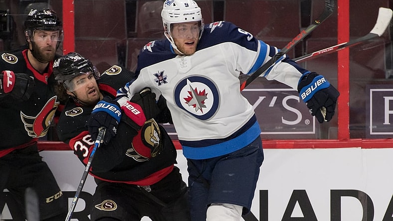 Jan 21, 2021; Ottawa, Ontario, CAN; Ottawa Senators center Colin White (36) is checked by Winnipeg Jets center Andrew Copp (9) in the second period at the Canadian Tire Centre. Mandatory Credit: Marc DesRosiers-USA TODAY Sports