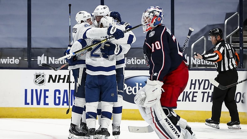 Jan 21, 2021; Columbus, Ohio, USA; Tampa Bay Lightning center Brayden Point (21) celebrates with teammates after scoring the game-winning goal against the Columbus Blue Jackets in the overtime period at Nationwide Arena. Mandatory Credit: Aaron Doster-USA TODAY Sports