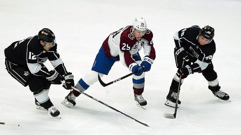 Jan 21, 2021; Los Angeles, California, USA; LA Kings center Trevor Moore (12) and center Blake Lizotte (46) battle for the puck with Colorado Avalanche center Nathan MacKinnon (29) in the second period at Staples Center. Mandatory Credit: Kirby Lee-USA TODAY Sports