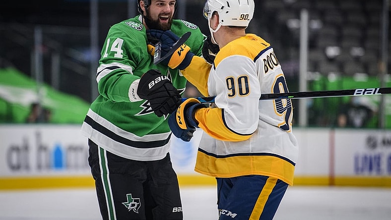 Jan 22, 2021; Dallas, Texas, USA; Dallas Stars left wing Jamie Benn (14) exchanges words with Nashville Predators defenseman Mark Borowiecki (90) during the first period at the American Airlines Center. Mandatory Credit: Jerome Miron-USA TODAY Sports