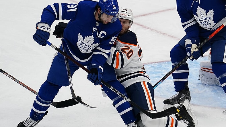 Jan 22, 2021; Toronto, Ontario, CAN; Edmonton Oilers defenceman Slater Koekkoek (20) defends against Toronto Maple Leafs forward John Tavares (91) during the second period at Scotiabank Arena. Mandatory Credit: John E. Sokolowski-USA TODAY Sports
