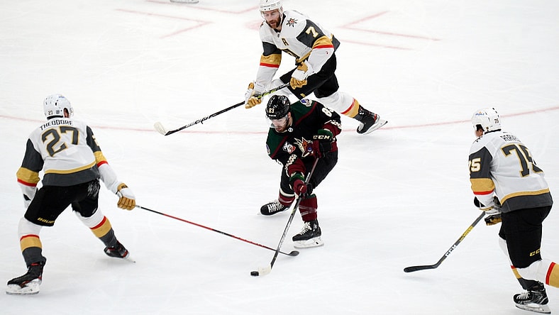 Jan 22, 2021; Glendale, Arizona, USA; Arizona Coyotes right wing Conor Garland (83) skates against Vegas Golden Knights defenseman Shea Theodore (27) and defenseman Alex Pietrangelo (7) and right wing Ryan Reaves (75) during the second period at Gila River Arena. Mandatory Credit: Joe Camporeale-USA TODAY Sports