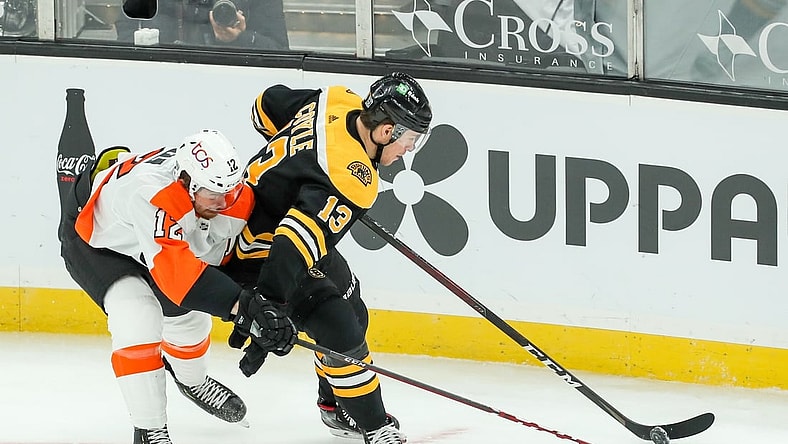 Jan 23, 2021; Boston, Massachusetts, USA; Philadelphia Flyers left wing Michael Raffl (12) defends Boston Bruins center Charlie Coyle (13) during the first period at TD Garden. Mandatory Credit: Paul Rutherford-USA TODAY Sports