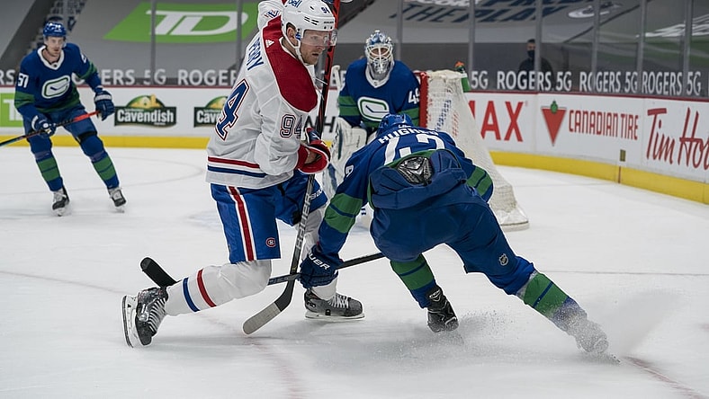 Jan 23, 2021; Vancouver, British Columbia, CAN; Vancouver Canucks defenseman Quinn Hughes (43) checks Montreal Canadiens forward Corey Perry (94) in the first period at Rogers Arena. Mandatory Credit: Bob Frid-USA TODAY Sports