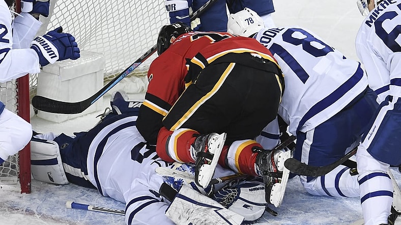 Jan 24, 2021; Calgary, Alberta, CAN; Calgary Flames forward Matthew Tkachuk (19) ends up on top of Toronto Maple Leafs goalie Jack Campbell (36) during the third period at Scotiabank Saddledome. Mandatory Credit: Candice Ward-USA TODAY Sports