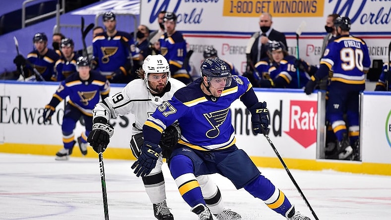 Jan 24, 2021; St. Louis, Missouri, USA;  St. Louis Blues left wing David Perron (57) handles the puck as Los Angeles Kings right wing Alex Iafallo (19) defends during the third period at Enterprise Center. Mandatory Credit: Jeff Curry-USA TODAY Sports