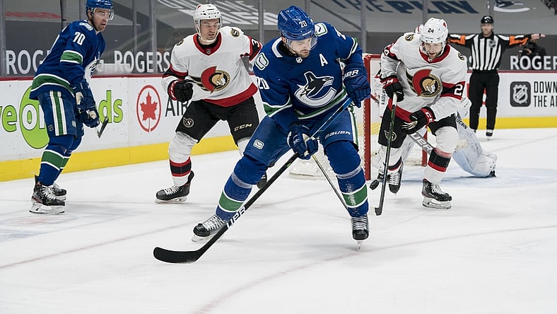 Jan 25, 2021; Vancouver, British Columbia, CAN; Ottawa Senators defenseman Christian Wolanin (24) checks Vancouver Canucks forward Brandon Sutter (20) in the first period at Rogers Arena. Mandatory Credit: Bob Frid-USA TODAY Sports