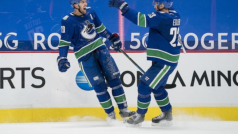Jan 25, 2021; Vancouver, British Columbia, CAN; Vancouver Canucks forward Brandon Sutter (20) and  defenseman Alexander Edler (23) celebrate Sutter s third goal of the game against the Ottawa Senators in the third period at Rogers Arena. Vancouver won 7-1.  Mandatory Credit: Bob Frid-USA TODAY Sports