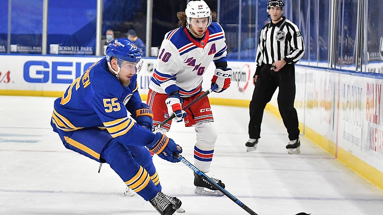Jan 26, 2021; Buffalo, New York, USA; Buffalo Sabres defenseman Rasmus Ristolainen (55) controls the puck in front of New York Rangers left wing Artemi Panarin (10) in the third period at KeyBank Center. Mandatory Credit: Mark Konezny-USA TODAY Sports
