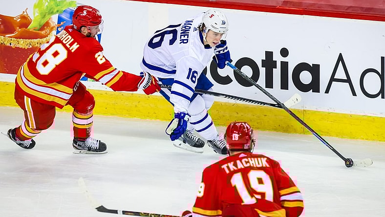Jan 26, 2021; Calgary, Alberta, CAN; Toronto Maple Leafs center Mitchell Marner (16) controls the puck against Calgary Flames center Elias Lindholm (28) during the second period at Scotiabank Saddledome. Mandatory Credit: Sergei Belski-USA TODAY Sports