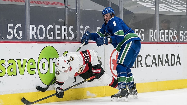 Jan 27, 2021; Vancouver, British Columbia, CAN; Vancouver Canucks forward J.T. Miller (9) checks Ottawa Senators defenseman Nikita Zaitsev (22) in the third period at Rogers Arena. Vancouver won 5-1. Mandatory Credit: Bob Frid-USA TODAY Sports