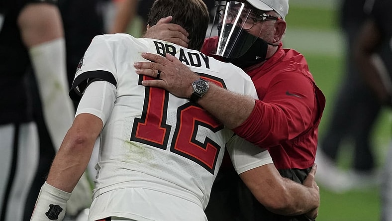 Oct 25, 2020; Paradise, Nevada, USA; Tampa Bay Buccaneers quarterback Tom Brady (12) and coach Bruce Arians embrace after the game against the Las Vegas Raiders at Allegiant Stadium. The Buccaneers defeated the Raiders 45-20. Mandatory Credit: Kirby Lee-USA TODAY Sports