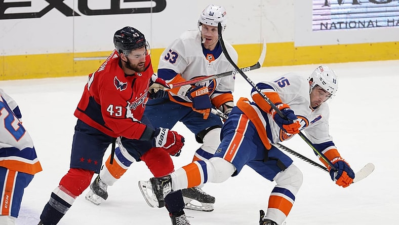Jan 28, 2021; Washington, District of Columbia, USA; Washington Capitals right wing Tom Wilson (43) trips New York Islanders right wing Cal Clutterbuck (15) while battling for the puck in the first period at Capital One Arena. Mandatory Credit: Geoff Burke-USA TODAY Sports