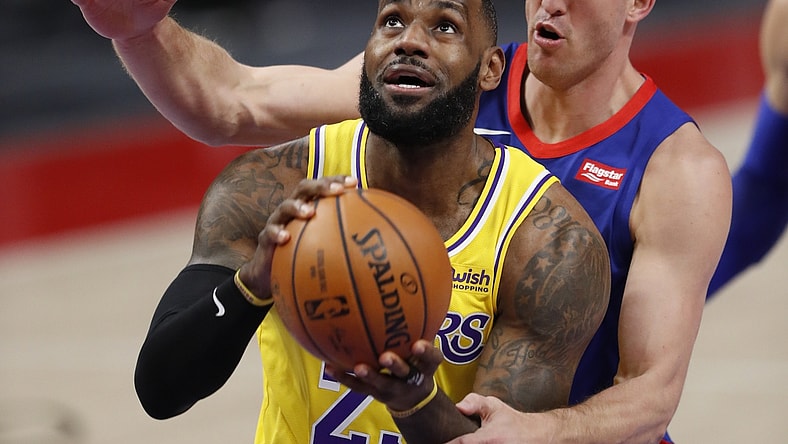 Jan 28, 2021; Detroit, Michigan, USA; Los Angeles Lakers forward LeBron James (23) gets fouled by Detroit Pistons center Mason Plumlee (24) during the first quarter at Little Caesars Arena. Mandatory Credit: Raj Mehta-USA TODAY Sports