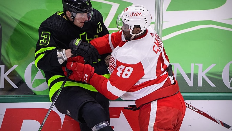 Jan 28, 2021; Dallas, Texas, USA; Detroit Red Wings right wing Givani Smith (48) checks Dallas Stars defenseman John Klingberg (3) during the first period at the American Airlines Center. Mandatory Credit: Jerome Miron-USA TODAY Sports