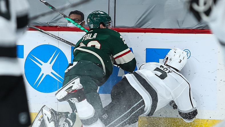 Jan 28, 2021; Saint Paul, Minnesota, USA; Minnesota Wild left wing Kevin Fiala (22) commits a boarding penalty against Los Angeles Kings defenseman Matt Roy (3) in the second period. Fiala was ejected from the game at Xcel Energy Center. Mandatory Credit: David Berding-USA TODAY Sports